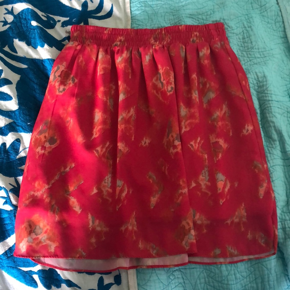 Multicolor skirt, & it isn’t short.